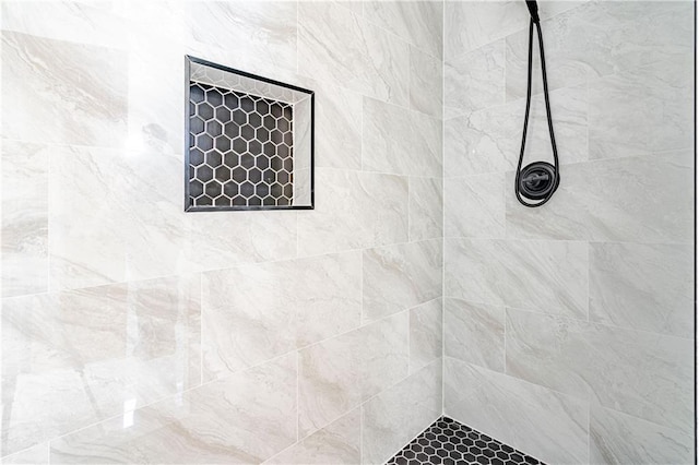 full bath with a tile shower