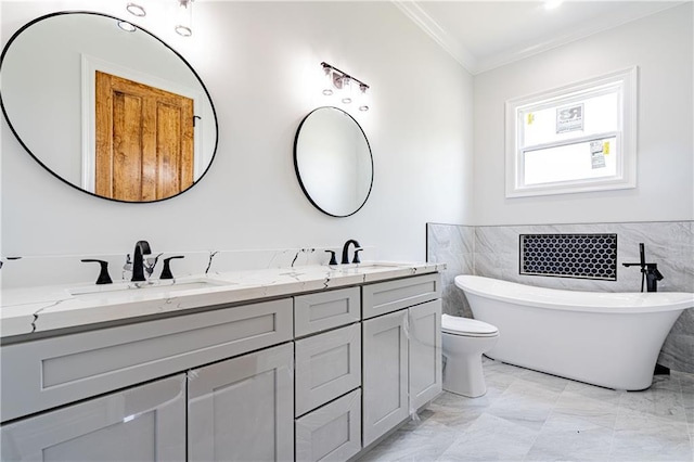 bathroom with crown molding, double vanity, a freestanding bath, and a sink