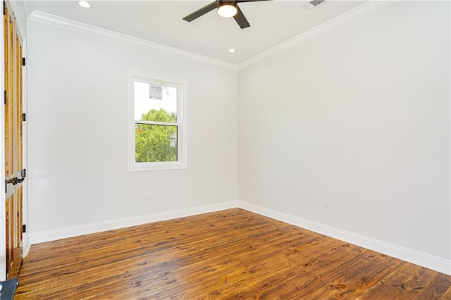 unfurnished room featuring baseboards, wood-type flooring, and crown molding