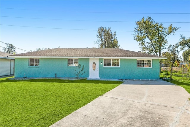 452 Maple Loop, La Place, LA 70068 - ranch-style house with concrete driveway, fence, and a front lawn