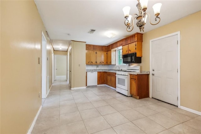 452 Maple Loop, La Place, LA 70068 - kitchen featuring brown cabinetry, visible vents, light countertops, a notable chandelier, and white appliances