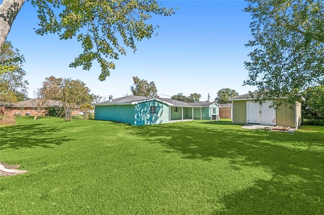 452 Maple Loop, La Place, LA 70068 - view of yard with a storage unit and an outdoor structure