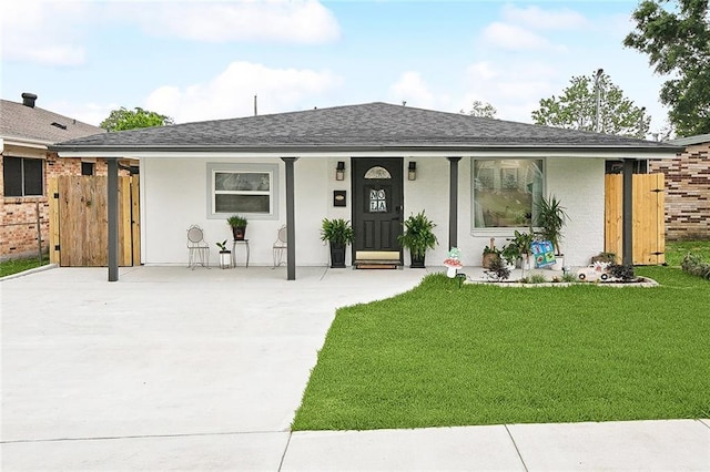 713 N Lester Ave, Metairie, LA 70003 - ranch-style home featuring fence, roof with shingles, a front lawn, stucco siding, and a porch