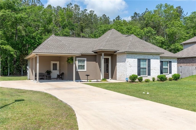 18203 Fox Hollow Loop, Hammond, LA 70401 - ranch-style home with fence, a shingled roof, an attached carport, a front yard, and concrete driveway