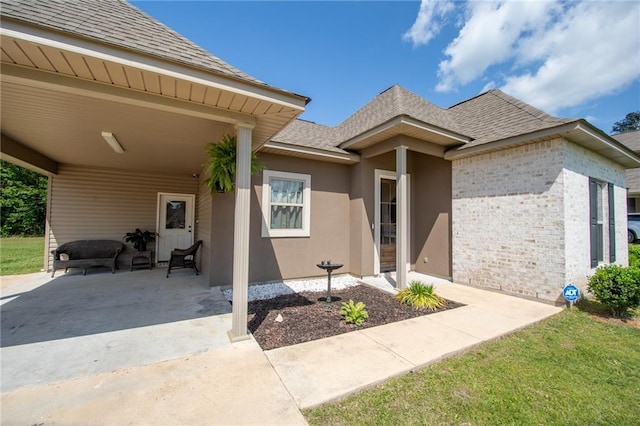 18203 Fox Hollow Loop, Hammond, LA 70401 - view of front of home with brick siding, roof with shingles, and a carport