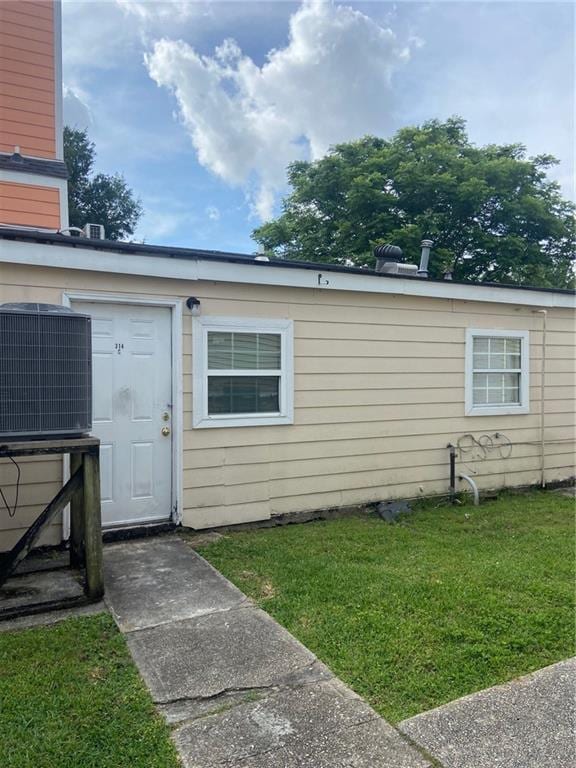 exterior space with a yard and central AC