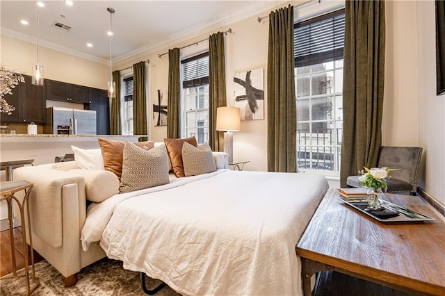 bedroom with stainless steel fridge, ornamental molding, recessed lighting, and visible vents