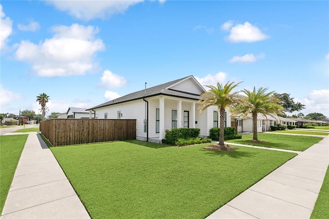 view of front of house featuring fence and a front yard