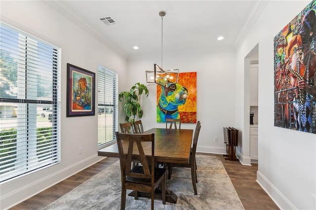 dining area featuring crown molding, plenty of natural light, and a chandelier