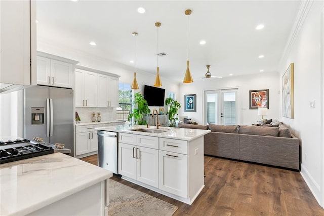 kitchen featuring a sink, appliances with stainless steel finishes, white cabinets, and open floor plan