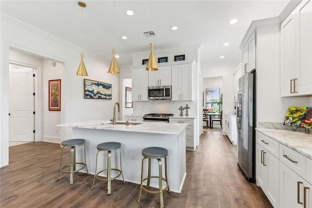 kitchen with visible vents, crown molding, dark wood finished floors, a sink, and stainless steel appliances