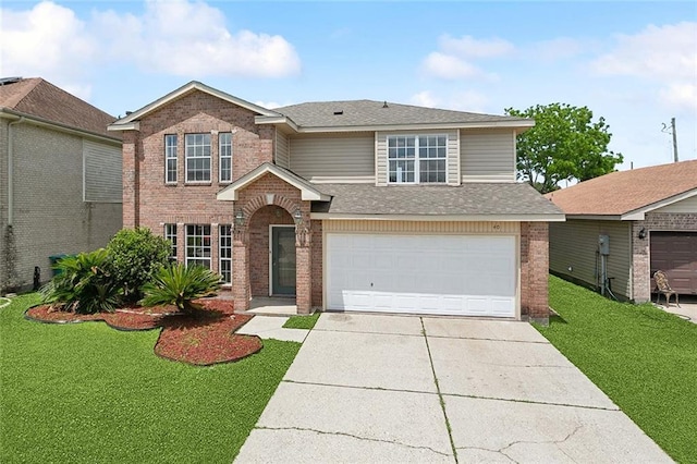 traditional-style home with concrete driveway, brick siding, an attached garage, and a front yard