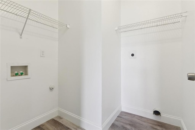 washroom featuring baseboards, laundry area, electric dryer hookup, and wood finished floors
