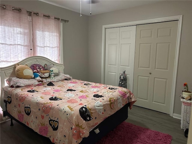 bedroom with wood finished floors and a closet