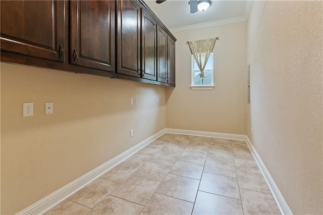 laundry room with crown molding, baseboards, light tile patterned floors, and ceiling fan