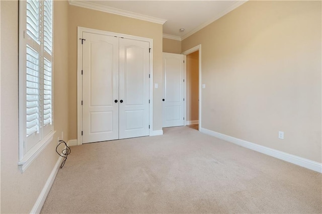 unfurnished bedroom with carpet floors, multiple windows, ornamental molding, and a closet