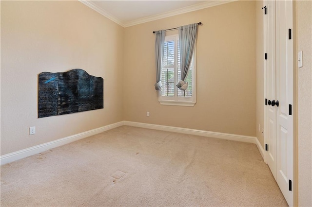 unfurnished room featuring crown molding, baseboards, and carpet flooring
