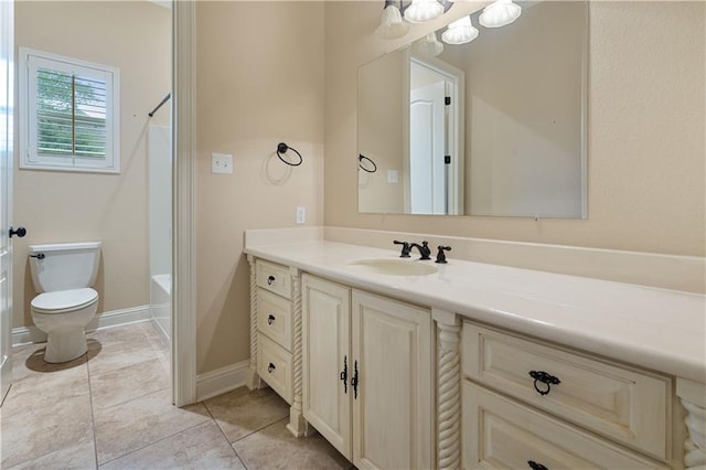 bathroom featuring bathtub / shower combination, vanity, toilet, tile patterned floors, and baseboards