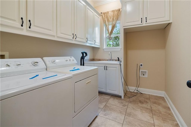 laundry area with washer and dryer, baseboards, a sink, and cabinet space