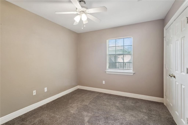 unfurnished bedroom featuring baseboards, ceiling fan, a closet, and dark carpet