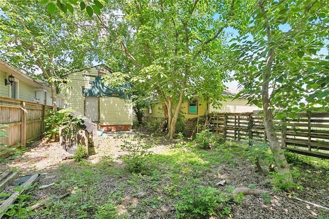 625 Forstall St, New Orleans, LA 70117 - view of yard with a fenced backyard, a storage unit, and an outdoor structure