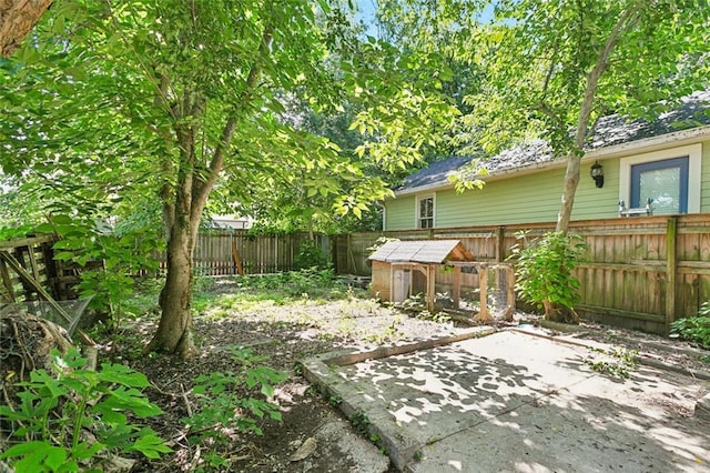 625 Forstall St, New Orleans, LA 70117 - view of yard featuring an outdoor structure, a fenced backyard, exterior structure, and a patio