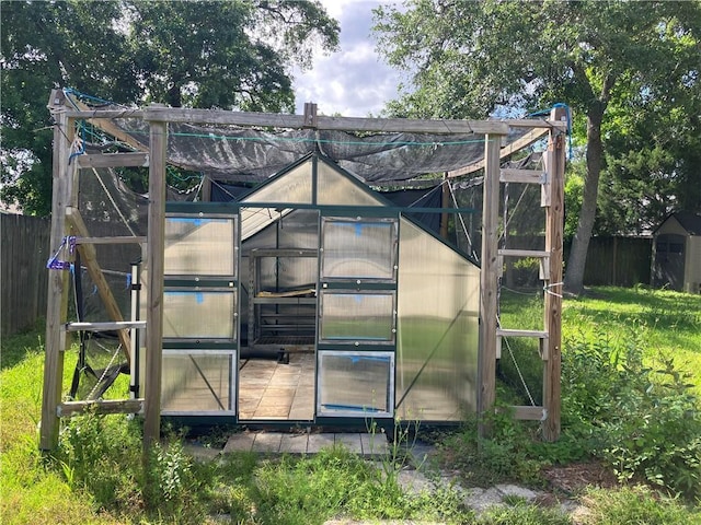 view of greenhouse with fence