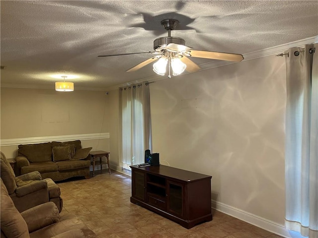living room with crown molding, a ceiling fan, a textured ceiling, and baseboards