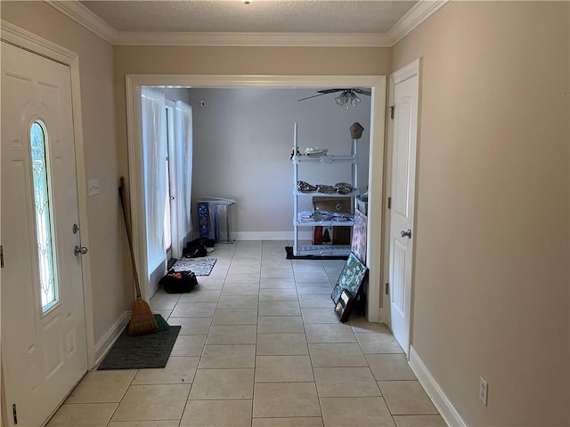 foyer entrance with baseboards, ornamental molding, a wealth of natural light, and light tile patterned floors