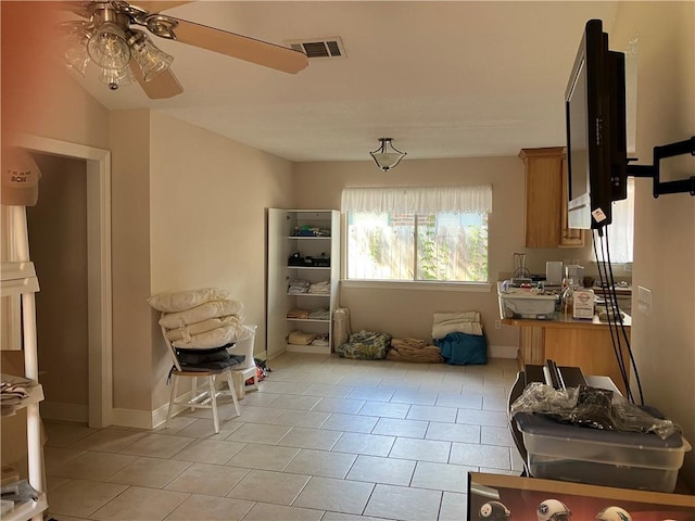 dining area featuring light tile patterned floors, baseboards, ceiling fan, and visible vents