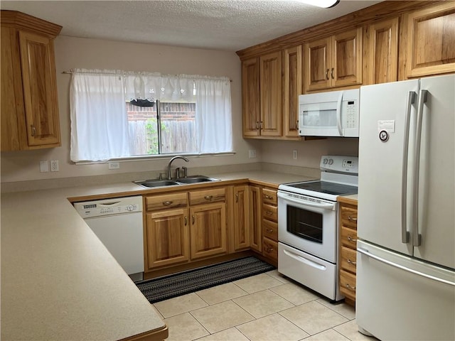 3837 Coventry St, Slidell, LA 70458 - kitchen featuring white appliances, light countertops, light tile patterned floors, brown cabinets, and a textured ceiling