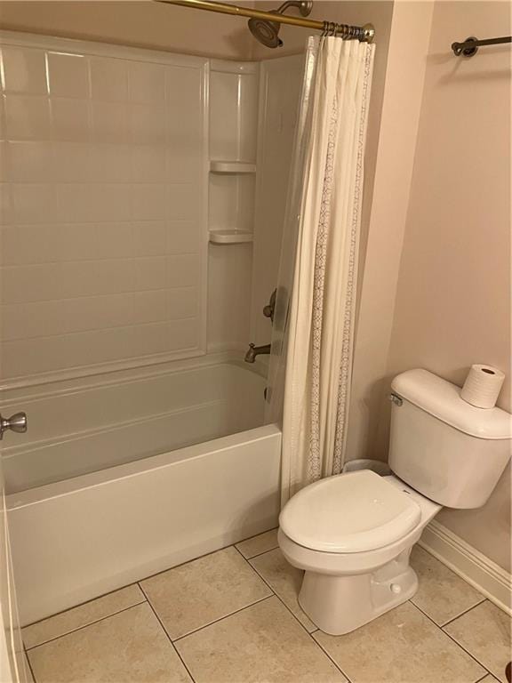 bathroom featuring toilet, baseboards, tile patterned flooring, and shower / tub combo