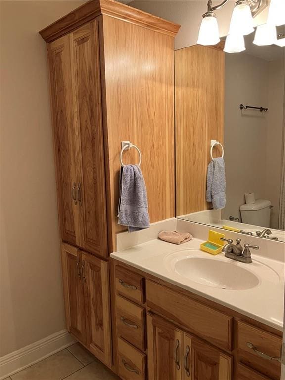 bathroom featuring vanity, tile patterned flooring, and toilet