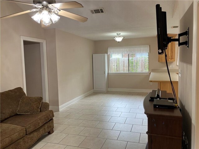 3837 Coventry St, Slidell, LA 70458 - living room featuring a ceiling fan, baseboards, and light tile patterned floors