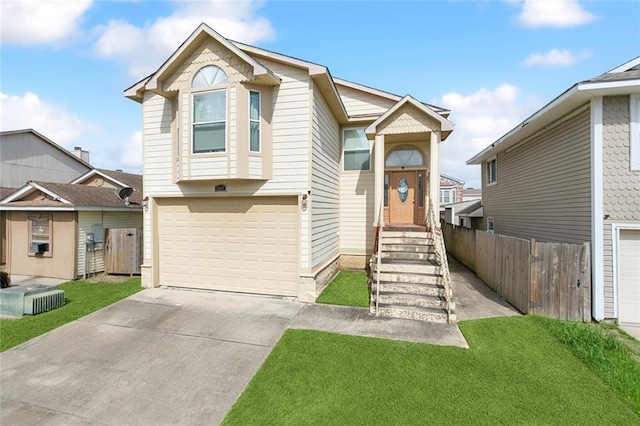 view of front of property with an attached garage, fence, a front yard, and concrete driveway