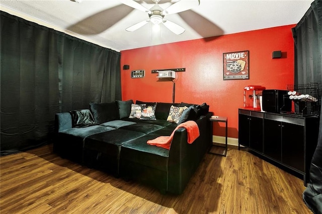 living room featuring a ceiling fan and wood finished floors