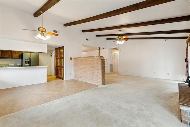 unfurnished living room featuring visible vents, ceiling fan, light tile patterned floors, and light colored carpet