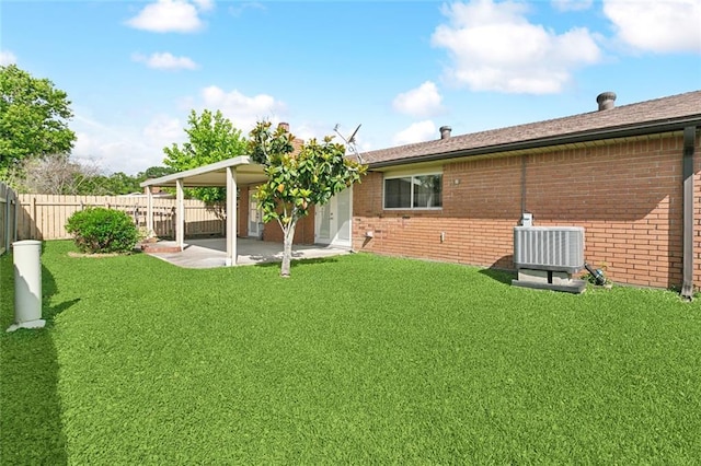rear view of property with brick siding, a fenced backyard, a lawn, and central AC