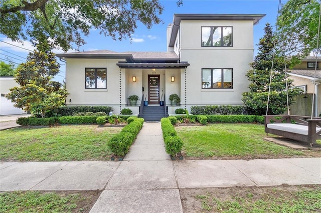 view of front of house featuring a front yard and stucco siding