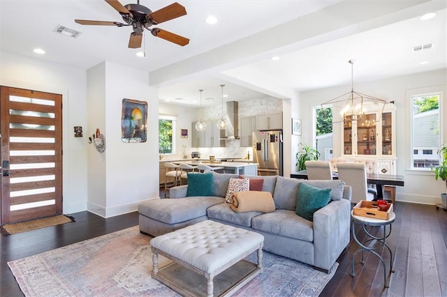 living room featuring baseboards, dark wood-style floors, and a wealth of natural light