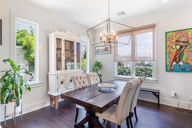 dining space featuring an inviting chandelier, baseboards, dark wood-type flooring, and visible vents