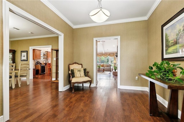 sitting room featuring crown molding, baseboards, dark wood-style flooring, and visible vents