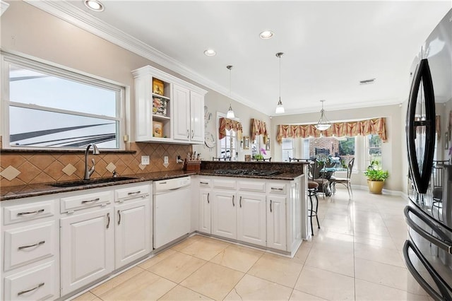 kitchen with freestanding refrigerator, gas cooktop, white cabinetry, a sink, and dishwasher