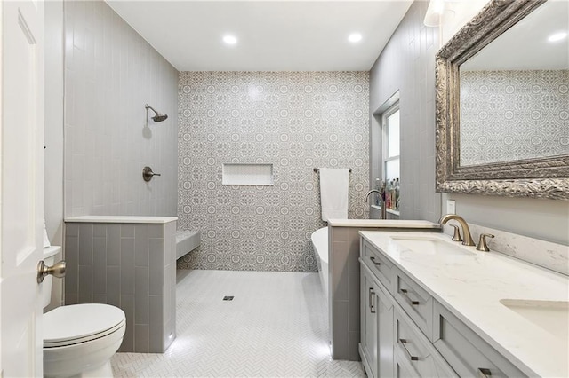 bathroom featuring walk in shower, a sink, double vanity, toilet, and a bathtub