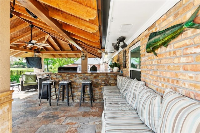 view of patio / terrace featuring grilling area, a gazebo, a ceiling fan, and outdoor wet bar