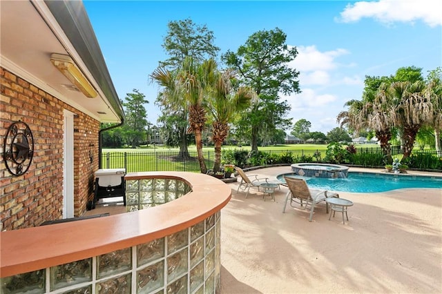 view of swimming pool with fence, a pool with connected hot tub, and a patio area