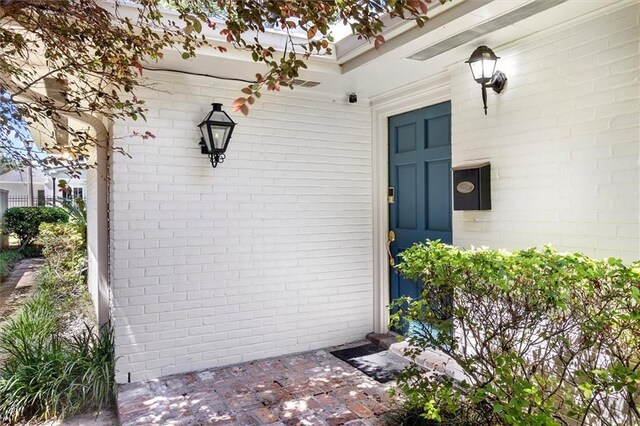 20 Thrasher St, New Orleans, LA 70124 - doorway to property featuring brick siding