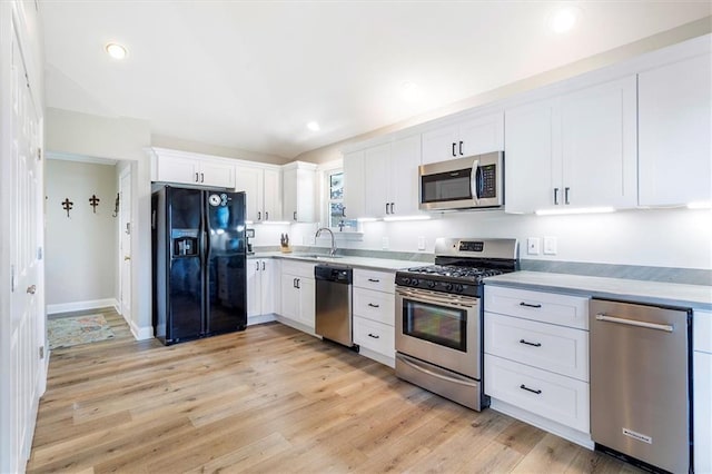 20 Thrasher St, New Orleans, LA 70124 - kitchen with light wood-type flooring, light countertops, white cabinetry, a sink, and appliances with stainless steel finishes