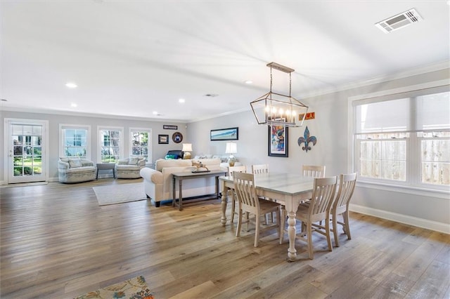 20 Thrasher St, New Orleans, LA 70124 - dining space with visible vents, wood finished floors, baseboards, an inviting chandelier, and ornamental molding