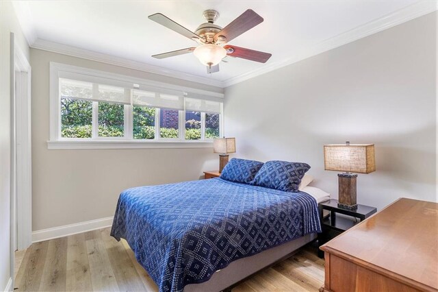 20 Thrasher St, New Orleans, LA 70124 - bedroom with crown molding, light wood finished floors, baseboards, and multiple windows